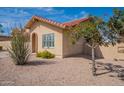View of the side of a single-story home with a red tile roof, with desert landscaping and a tree at 4538 E Shomi St, Phoenix, AZ 85044