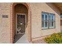 Close-up of a brick-lined front door with a security screen, desert-themed decoration, and house number 4538 at 4538 E Shomi St, Phoenix, AZ 85044