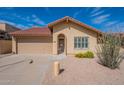 Single-story home with a red tile roof and desert landscaping, including cacti and yellow flowers at 4538 E Shomi St, Phoenix, AZ 85044