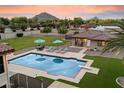 Inviting pool area with lounge chairs and mountain views at 5044 W Electra Ln, Glendale, AZ 85310