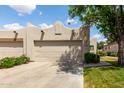 Lovely home with a two-car garage, xeriscaping, and a well-manicured lawn at 5445 E Mckellips Rd # 48, Mesa, AZ 85215