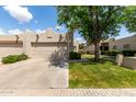 Charming single-story home with a two-car garage and desert landscaping at 5445 E Mckellips Rd # 48, Mesa, AZ 85215
