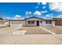 Charming single-story home with a well-maintained front yard and a two-car garage, perfect for suburban living at 5818 E Colby St, Mesa, AZ 85205