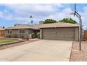 Home with a brick facade, a two-car garage, and a concrete driveway at 5926 S Newberry Rd, Tempe, AZ 85283