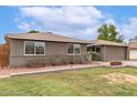 Inviting home with a brick facade, neutral color palette, and mature landscaping at 5926 S Newberry Rd, Tempe, AZ 85283