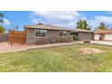 Inviting home with a brick facade, neutral color palette, and mature landscaping at 5926 S Newberry Rd, Tempe, AZ 85283