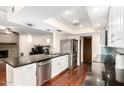 Modern kitchen featuring dark countertops, stainless steel appliances, and wood flooring at 5926 S Newberry Rd, Tempe, AZ 85283