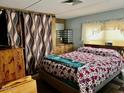 Comfortable bedroom with a cozy bed, natural light, and a functional furniture arrangement at 5933 E Main St # 114, Mesa, AZ 85206