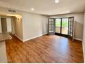 Spacious living area featuring wood flooring and sliding glass doors to the outside at 5995 N 78Th St # 1047, Scottsdale, AZ 85250