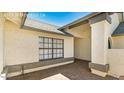 Open entryway with a large window and brick-paved patio at 6601 W Montego Ln, Glendale, AZ 85306