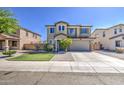 Beautiful two-story house with a well-kept lawn, desert landscape and a spacious two-car garage at 6811 W Darrel Rd, Laveen, AZ 85339