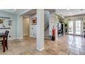 Bright living area boasts travertine flooring and access to stairs and a pool through large sliding glass doors at 8830 S 20Th S Pl, Phoenix, AZ 85042