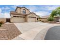 Beautiful two-story home showcasing a three-car garage, desert landscaping, and ample parking space at 9825 E Gary St, Mesa, AZ 85207