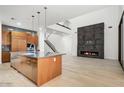 Gourmet kitchen with island, open to the living area with modern fireplace at 100 W Northern Ave # 7, Phoenix, AZ 85021