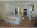 Bright kitchen featuring white cabinets, stainless appliances, subway tile backsplash, and an island with seating at 1010 N Osprey Ct, Gilbert, AZ 85234