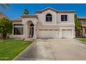 Charming two-story home with a three car garage, well-manicured lawn, and an arched entryway at 1014 W Mulberry Dr, Chandler, AZ 85286