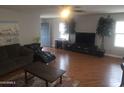 Spacious living room with natural light and a desert painting on the wall at 11770 W Aster Dr, El Mirage, AZ 85335