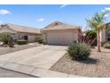 Single-story home with desert landscaping, a concrete driveway, and a two-car garage at 1241 E Elm Rd, San Tan Valley, AZ 85140