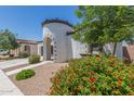 Charming home exterior showcases a turret entryway with red tile details and lush landscaping at 22876 E Via Del Sol --, Queen Creek, AZ 85142