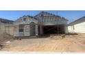 Exterior framing of a new home featuring modern architecture and design during the construction phase at 24260 W Pecan Rd, Buckeye, AZ 85326