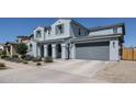 Spacious two-story home with an attached two-car garage and neatly maintained desert landscaping at 25051 N 140Th Dr, Surprise, AZ 85387