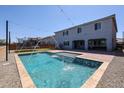 Inviting backyard with a sparkling pool and a well-maintained lawn, perfect for outdoor gatherings and enjoyment at 25051 N 140Th Dr, Surprise, AZ 85387