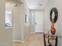 Welcoming neutral foyer features tile flooring and contemporary decor at 27023 N 130Th Gln, Peoria, AZ 85383