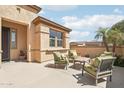 Relaxing outdoor seating area offers ample space for entertaining with potted plants and desert landscaping at 27023 N 130Th Gln, Peoria, AZ 85383