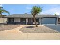 Inviting single-story home features a tidy yard, a stone walkway, and a charming front facade at 2708 E Villa Theresa Dr, Phoenix, AZ 85032