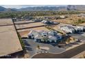 Beautiful aerial view of luxury estate in a neighborhood with mountain backdrop at 3518 N 201St Ln, Buckeye, AZ 85396
