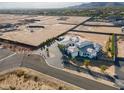 Expansive aerial view of luxury home, large lot, circular driveway, and mountain views at 3518 N 201St Ln, Buckeye, AZ 85396