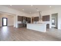 Spacious kitchen with stainless steel appliances, gray cabinets, a white island, and tiled floors at 3824 W Lodge Dr, Laveen, AZ 85339