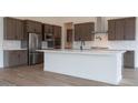 Modern kitchen featuring stainless steel appliances, a large island with counter seating, and subway tile backsplash at 3824 W Lodge Dr, Laveen, AZ 85339