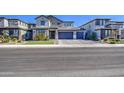 Charming two-story home with a three car garage, manicured lawn, and desert landscaping at 4507 S 119Th Dr, Avondale, AZ 85323