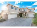 Inviting home exterior featuring a three-car garage and meticulously landscaped front yard at 4960 E Colonial Dr, Chandler, AZ 85249