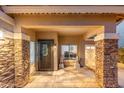 Charming front porch with decorative stonework, an ornate front door and detailed lion statues at 4960 E Colonial Dr, Chandler, AZ 85249