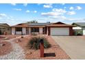 Charming single-story home features a two-car garage, solar panels, and a low maintenance xeriscaped yard at 5808 W Acoma Dr, Glendale, AZ 85306