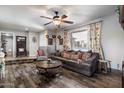 Cozy living room features stylish decor, a large sofa, and views to the entry and adjacent dining room at 5808 W Acoma Dr, Glendale, AZ 85306