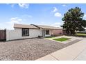 Inviting single-story house with a carport, low maintenance yard, and a neatly landscaped entryway at 6313 W Carol Ave, Glendale, AZ 85302