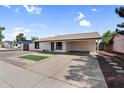 Well-maintained single-story home featuring a covered carport and low maintenance landscaping at 6313 W Carol Ave, Glendale, AZ 85302