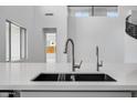 Stylish kitchen sink with modern faucets, complemented by bright interiors at 8426 W Solano Dr, Glendale, AZ 85305