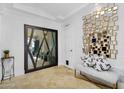 Bright entry way with decorative mirror wall and geometric glass door at 8935 N 82Nd St, Scottsdale, AZ 85258
