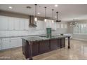 Spacious kitchen features an oversized island, stainless steel appliances, and white cabinetry at 9041 W Redbird Rd, Peoria, AZ 85383