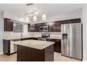 Bright kitchen with stainless steel appliances, granite countertops, and a center island at 1002 W Villa Rita Dr, Phoenix, AZ 85023