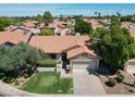Aerial view of home with tile roof, desert landscaping, and lush green trees at 1226 E Greenway Cir, Mesa, AZ 85203