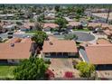 The house has a nice roof and backyard with lush green trees at 1226 E Greenway Cir, Mesa, AZ 85203