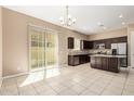 Bright open kitchen with stainless steel appliances, a granite countertop island, and sliding glass doors at 1367 S Country Club Dr # 1299, Mesa, AZ 85210