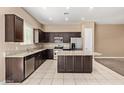 Modern kitchen featuring stainless steel appliances, a granite countertop, and a center island at 1367 S Country Club Dr # 1299, Mesa, AZ 85210
