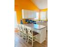 Eat-in kitchen with white cabinetry, a center island and wood-look floors at 15897 N Gil Balcome St, Surprise, AZ 85374