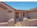 Welcoming front entrance with decorative columns and a beautifully designed pathway at 16313 W Escondido Ct, Surprise, AZ 85374